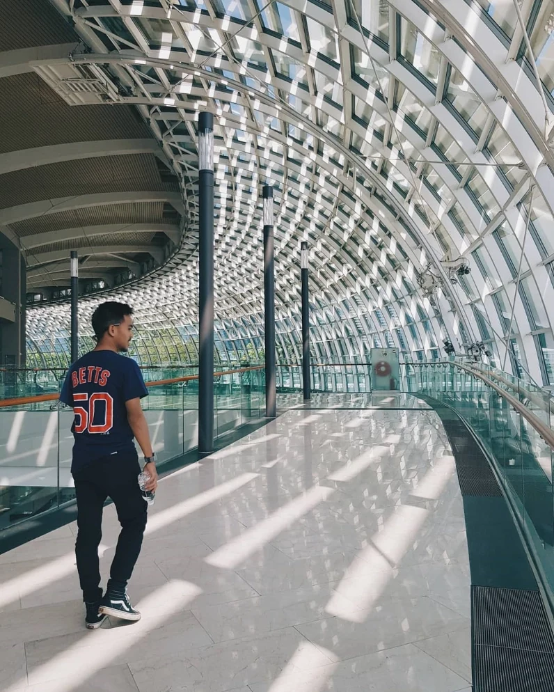 A travel moment beneath a glass and steel canopy